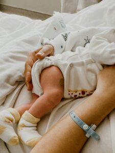 Tender moment captured between mother and newborn baby in a hospital setting. safe place
